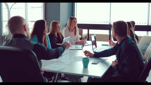 Director Is Talking To His Colleagues in the Office, Sitting at the Table. Teamwork