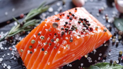 Close Up of Raw Salmon with Salt and Pepper