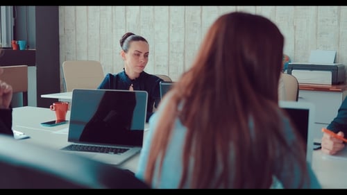 Companions and the Head of the Company Study Graphs and Diagrams on Sheets on the Office Table at a