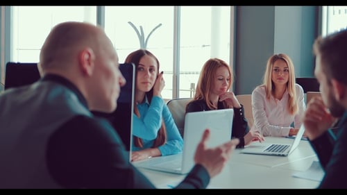 Group of Business Partners on Meeting Discussing Deal at Table in the Office