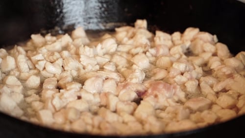 Finely Chopped Chicken Is Fried on Frying Pan