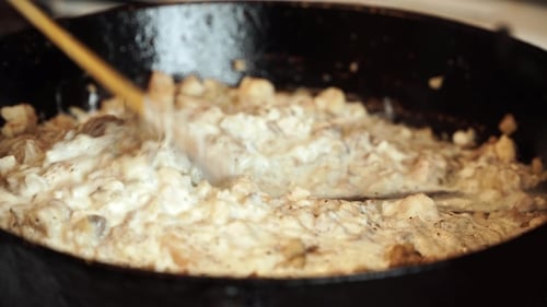 Meat with Black Pepper and Gravy Mix in Pan with Wooden Spatula