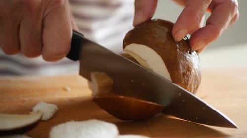 Slicing Fresh Mushroom on Cutting Board