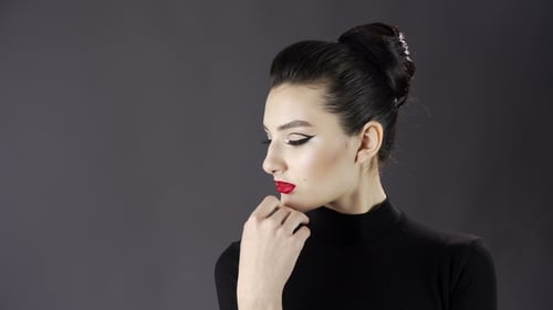 Portrait of a Beautiful Sexy Girl. Fashion Model Posing on a Dark Background for Studio Photo Shoot