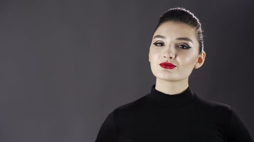 Portrait of a Beautiful Sexy Girl. Fashion Model Posing on a Dark Background for Studio Photo Shoot