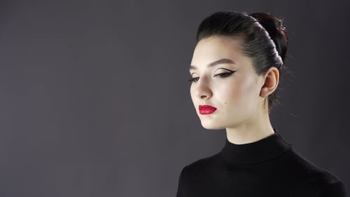 Portrait of a Beautiful Sexy Girl. Fashion Model Posing on a Dark Background for Studio Photo Shoot