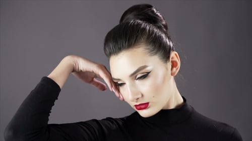Portrait of a Beautiful Sexy Girl. Fashion Model Posing on a Dark Background for Studio Photo Shoot