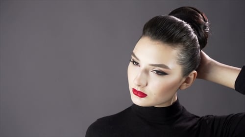 Portrait of a Beautiful Sexy Girl. Fashion Model Posing on a Dark Background for Studio Photo Shoot