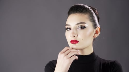 Portrait of a Beautiful Sexy Girl. Fashion Model Posing on a Dark Background for Studio Photo Shoot