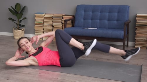 Fit Woman Does Abdominal Exercises at Home