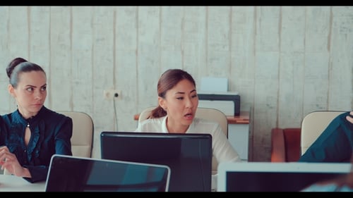 Asian Girl Behind Laptops in the Office Communicates with Colleagues, They Team Discuss Business