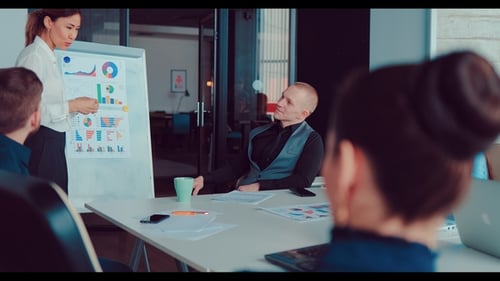 Office Meeting with Data Presentation in Modern Workplace