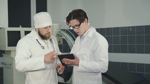 Two Doctors Consulting Using Tablet in the Clinic