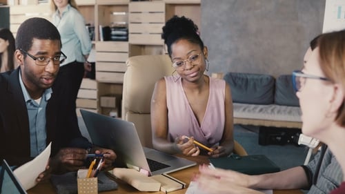 Mixed Ethnicity Team Meeting in Trendy Office. Happy Smiling Creative Millennials Brainstorm