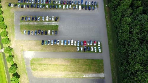 Aerial View of a Huge Car Parking Lot Panning from the Single Car To Many and Back
