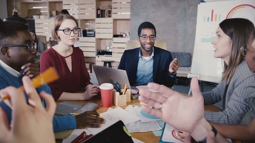 Multiethnic Colleagues Talking at Office Meeting. Happy Young Business People Developing Partnership