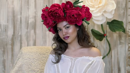 Woman with Red Floral Crown Posing Indoors