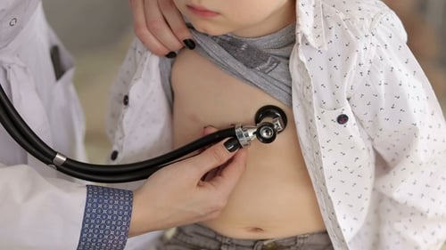 Doctor Examines Young Boy with Stethoscope in Clinic