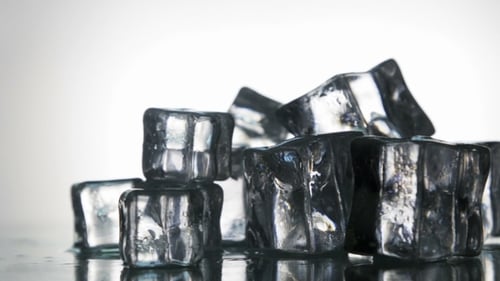 Melting Ice Cubes on Reflective Surface