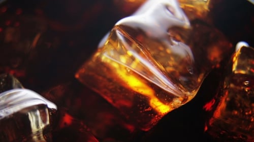 Refreshing Ice Cubes Submerged in a Dark Drink