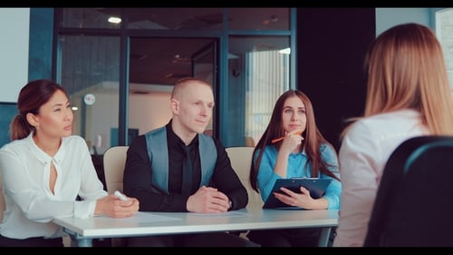 Panel Interviewing Job Candidate in Bright Office