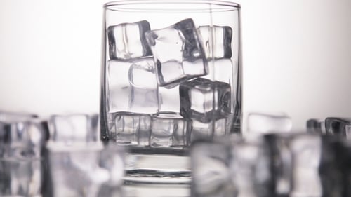 Soda Pouring into Glass with Ice Cubes