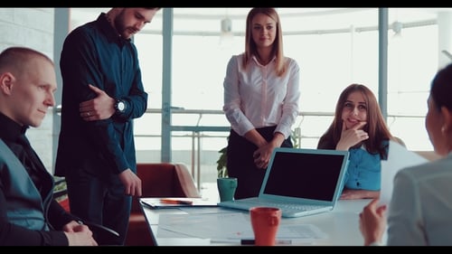 Companions and the Head of the Company Study Graphs and Diagrams on Sheets on the Office Table at a