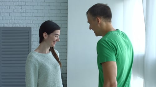 Loving Couple Sharing Flowers and a Kiss Indoors