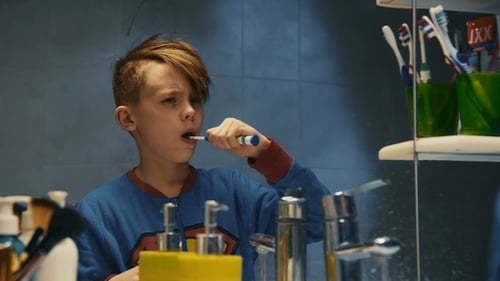 Kid Brushing Teeth in Bathroom