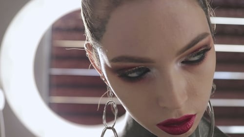Stylish Woman with Elaborate Makeup and Accessories Posing