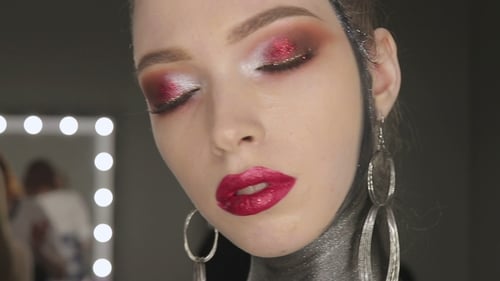 Glamorous Woman with Dramatic Makeup and Elegant Jewelry