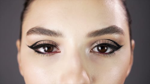 Eyes of a Beautiful Sexy Girl. Fashion Model Posing on a Dark Background for Studio Photo Shoot