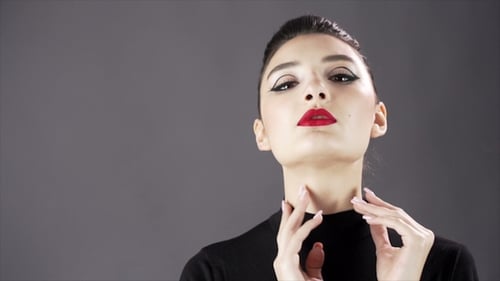 Woman with Elegant Hair Bun and Red Lipstick