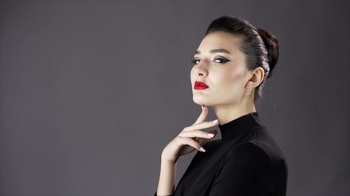Elegant Woman Posing in Studio with Glamorous Makeup