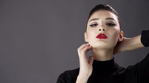 Portrait of a Beautiful Sexy Girl. Fashion Model Posing on a Dark Background for Studio Photo Shoot