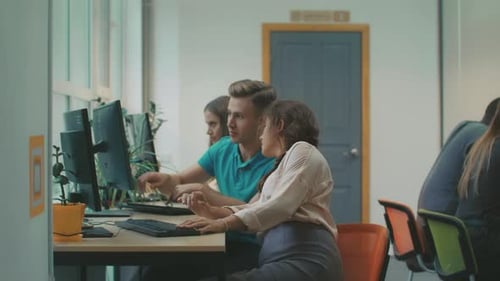 Man and Woman Work at Computer in Office