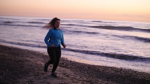 Fitness Woman Runner Running on the Beach
