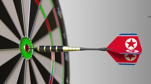 Flags of Australia and North Korea on Darts Hitting Bullseye of the Target