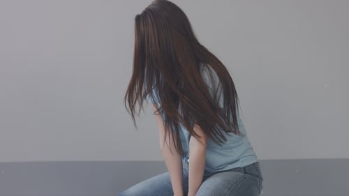 Caucasian Young Woman with Long Hair in Studio