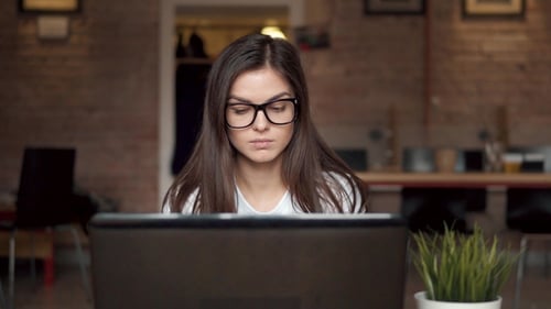 Woman Works at Her Laptop in Office