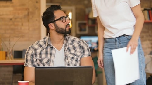 Woman Sits Next To Busy Man