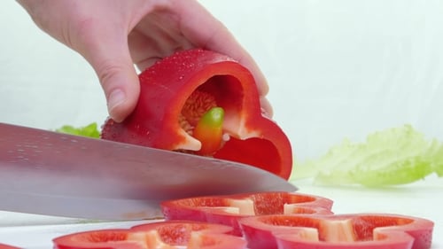 Slicing a Fresh Red Bell Pepper With Knife