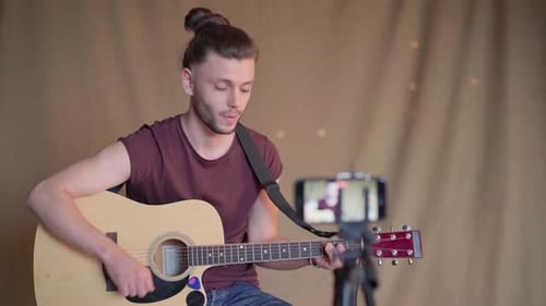 Man Playing Acoustic Guitar for Video Recording