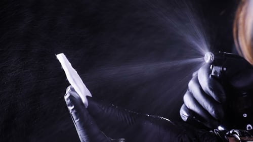 Spraying Sanitizer onto Cleaning Wipe in Studio