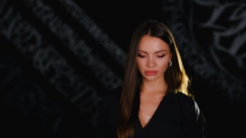 Beautiful Woman Posing in Front of Dark Background