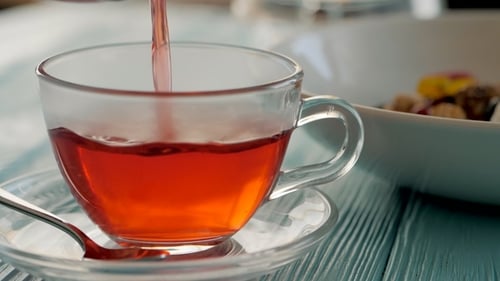 Red Liquid Poured Into Clear Glass Cup