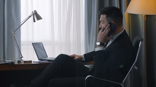 Man in Suit Working at Desk on Laptop
