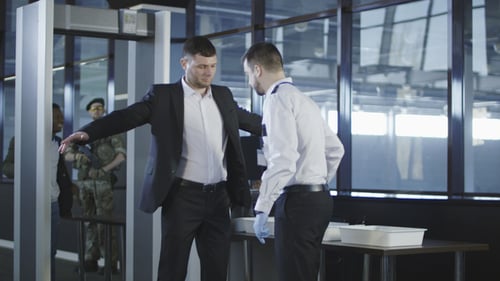 Man Being Scanned at Airport Security Checkpoint