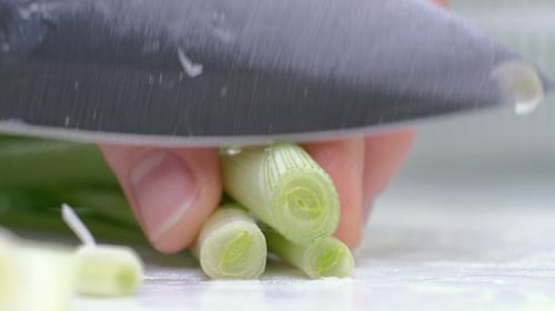 Cut the Green Onions with a Knife on the Board. Cutting Green Without Hands in the Frame. Chef Cuts