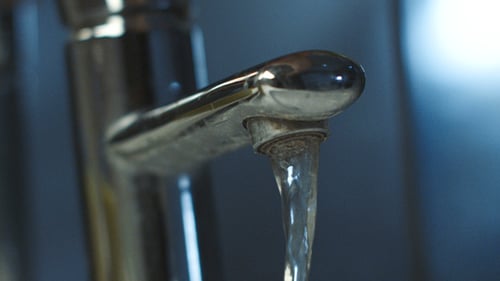 Close Up of Shiny Faucet with Running Water